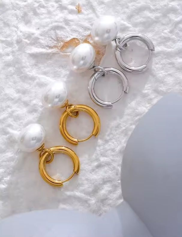 Boucles d'oreilles Perla: Perles goutte suspendues sur base dorée pour une élégance subtile et un style féminin, chic au quotidien comme en soirée. 